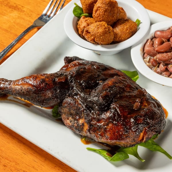 Felix's BBQ with Soul's BBQ chicken with sides of hush puppies and red beans.