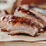 Closeup of pork ribs grilled with BBQ sauce and caramelized in honey.